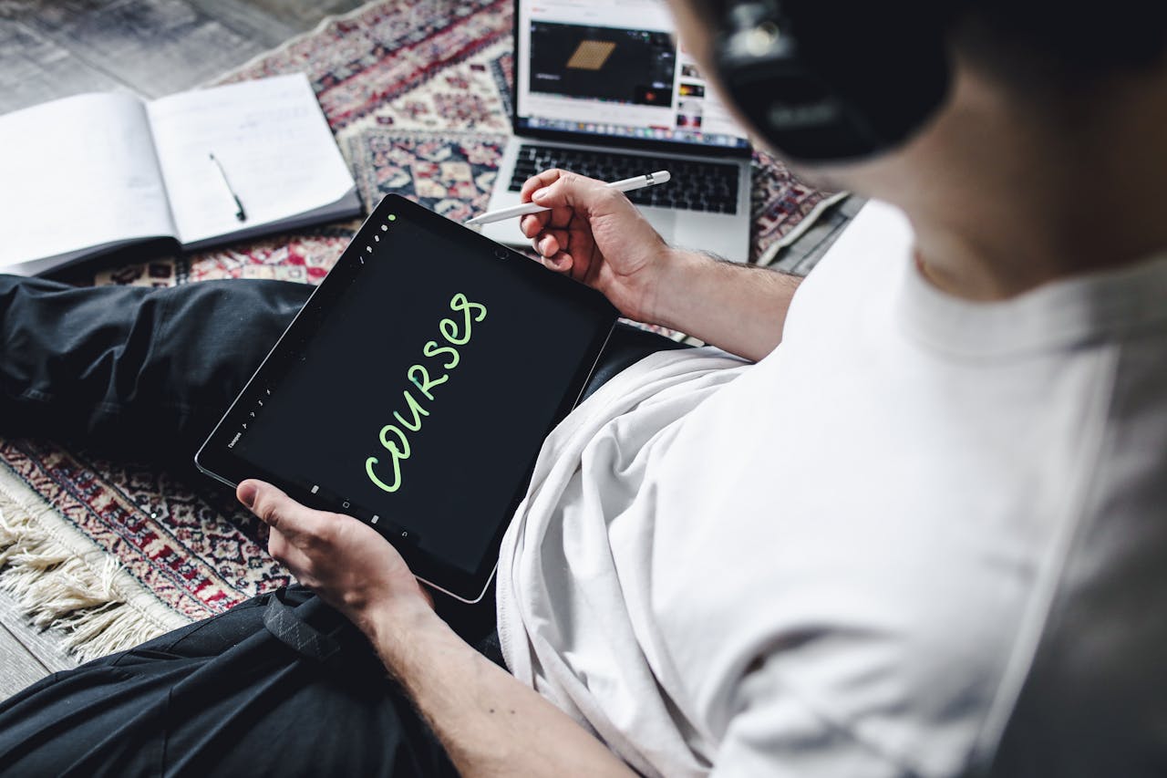 client-satisfaction-img Person studying online courses using a digital tablet while relaxing indoors with headphones.